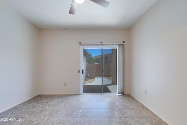 empty room featuring baseboards and a ceiling fan