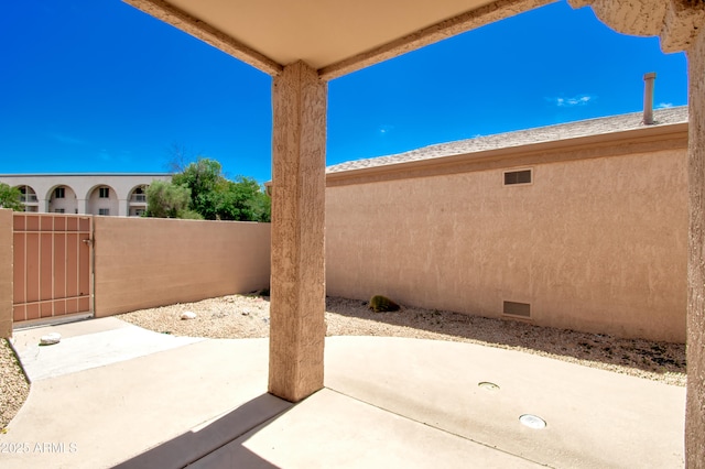 view of patio / terrace with fence and a gate