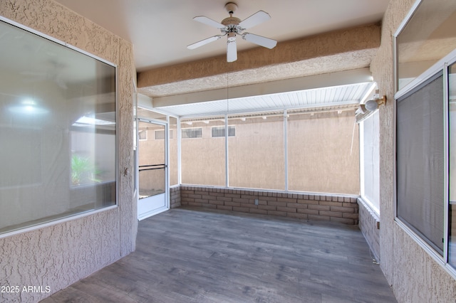 unfurnished sunroom featuring ceiling fan