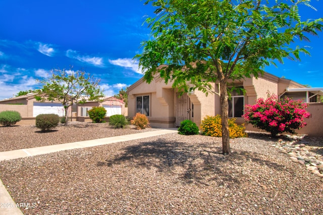 view of front of home with fence and stucco siding