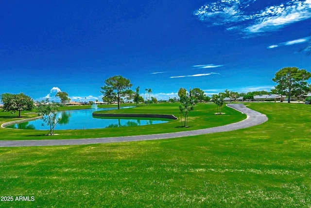 surrounding community featuring a lawn and a water view