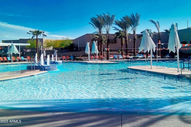 community pool with fence and a patio area