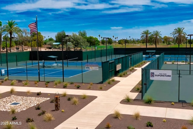 view of tennis court featuring fence