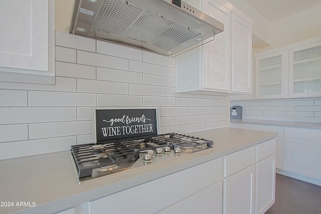 kitchen featuring white cabinets, custom range hood, stainless steel gas cooktop, backsplash, and tile floors