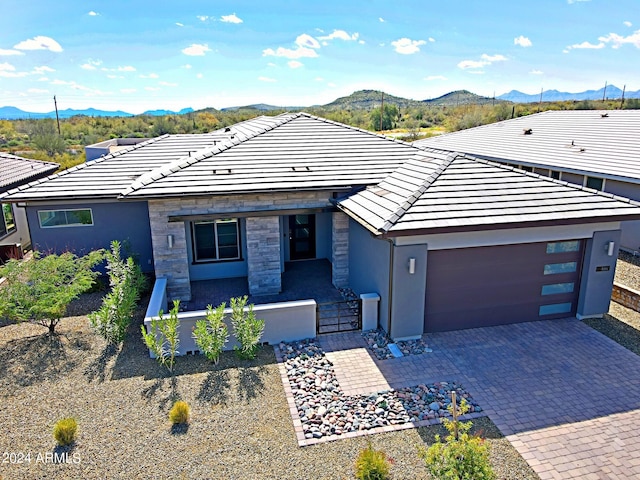 view of front of property with a mountain view and a garage