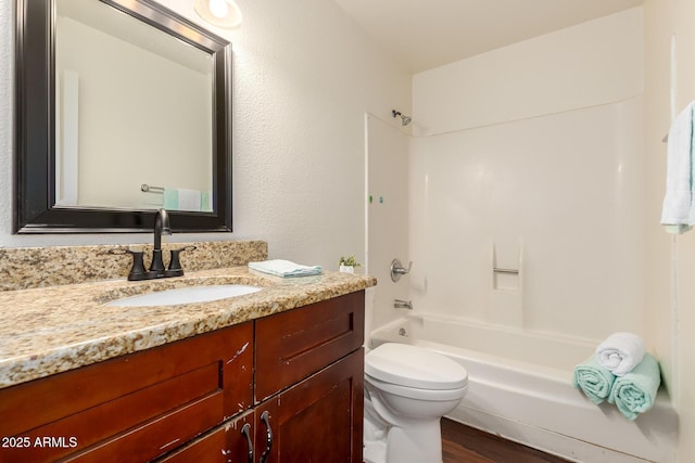 4802 W Hayward Ave, Glendale, AZ 85301 - bathroom with vanity, toilet, wood finished floors, and washtub / shower combination