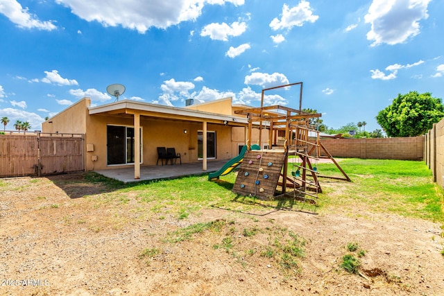 4802 W Hayward Ave, Glendale, AZ 85301 - back of property featuring stucco siding, a playground, a fenced backyard, and a patio