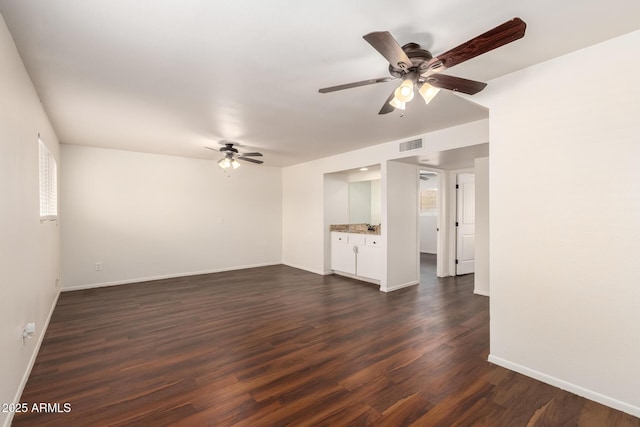 4802 W Hayward Ave, Glendale, AZ 85301 - unfurnished living room with a ceiling fan, dark wood-type flooring, and baseboards