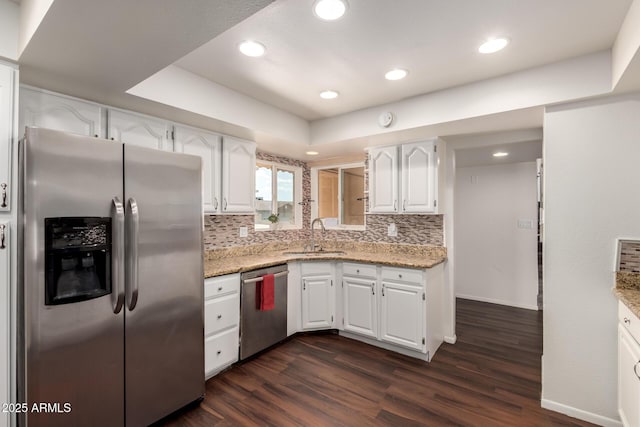 4802 W Hayward Ave, Glendale, AZ 85301 - kitchen with stainless steel appliances, a sink, white cabinetry, dark wood-type flooring, and backsplash