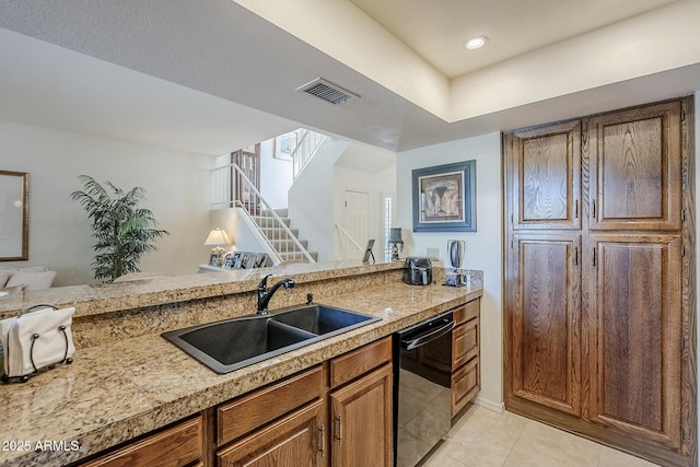 kitchen with visible vents, light countertops, a sink, dishwashing machine, and light tile patterned flooring