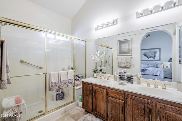 full bath featuring a sink, a stall shower, ensuite bath, and lofted ceiling