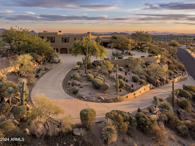 aerial view at dusk featuring a mountain view