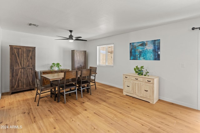 dining space with light hardwood / wood-style floors and ceiling fan