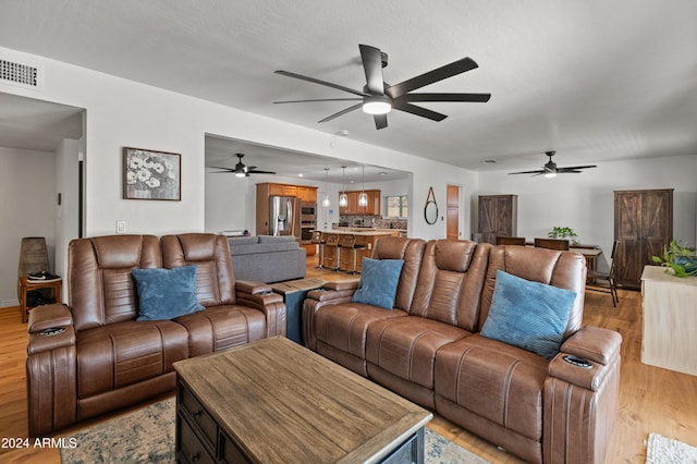 living room featuring a textured ceiling and light wood-type flooring