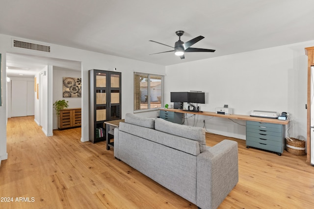 living room featuring ceiling fan and light hardwood / wood-style flooring