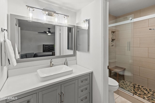 bathroom with ceiling fan, toilet, walk in shower, tile patterned floors, and vanity