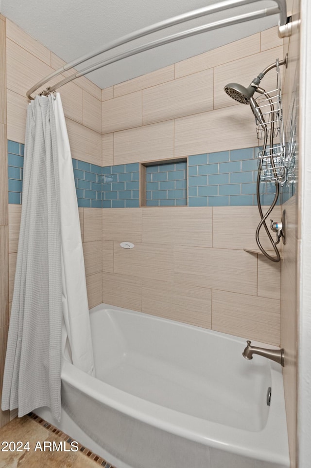 bathroom with shower / bathtub combination with curtain and tile patterned floors