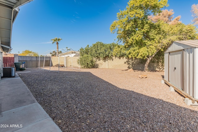 view of yard with a patio and a storage shed