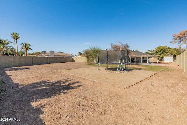 view of yard with a trampoline