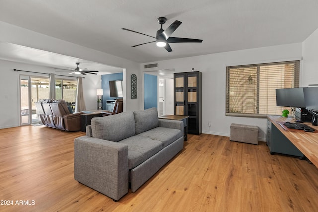 living room with ceiling fan and light hardwood / wood-style floors