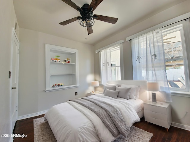 bedroom featuring multiple windows, dark hardwood / wood-style flooring, and ceiling fan