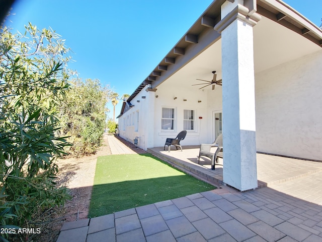 exterior space featuring ceiling fan