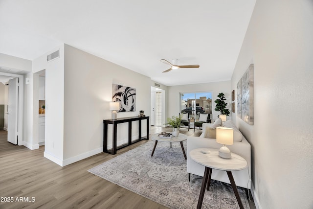 living room featuring light wood-type flooring and ceiling fan