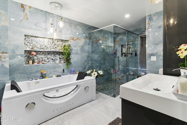 bathroom with vanity, tile walls, and shower with separate bathtub