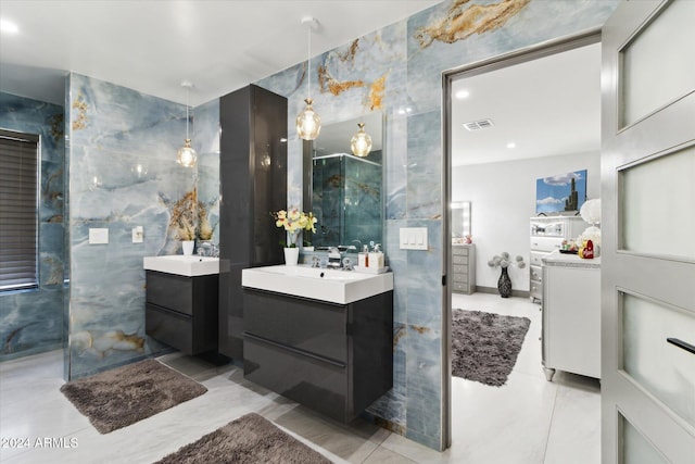 bathroom featuring vanity and tile walls