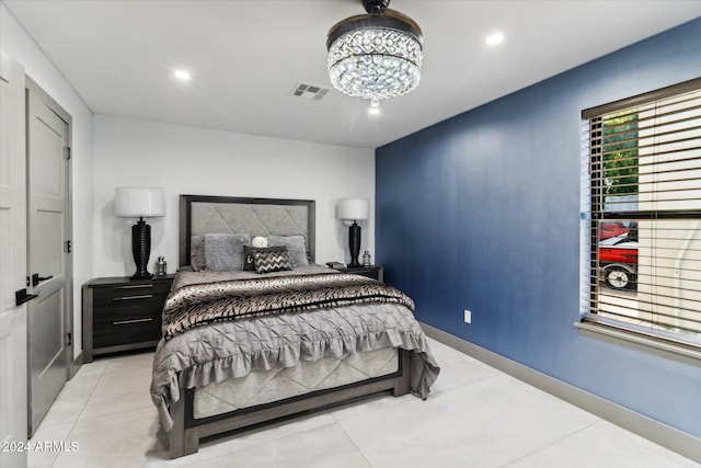 tiled bedroom with an inviting chandelier