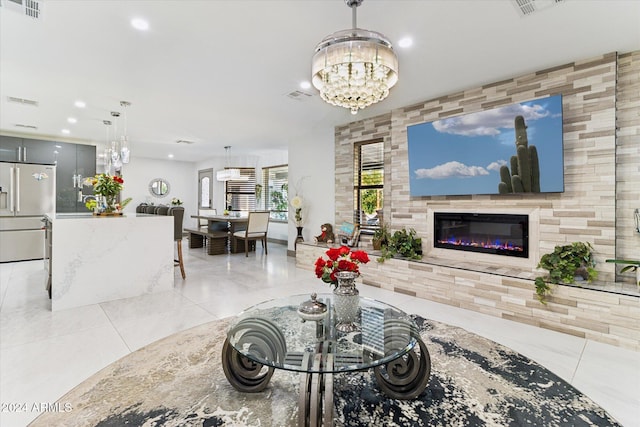 living room with light tile patterned floors and a notable chandelier