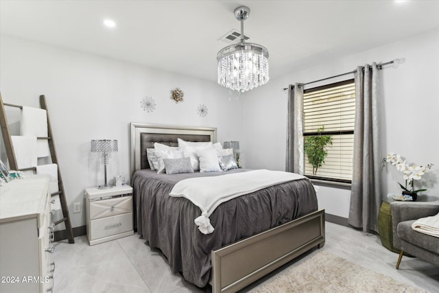 bedroom with a notable chandelier