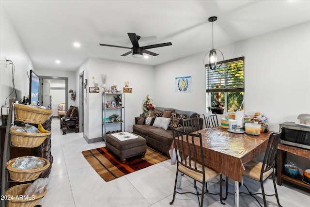 living room with ceiling fan and light tile patterned flooring