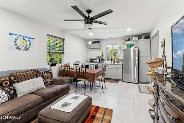 living room featuring ceiling fan and light tile patterned floors