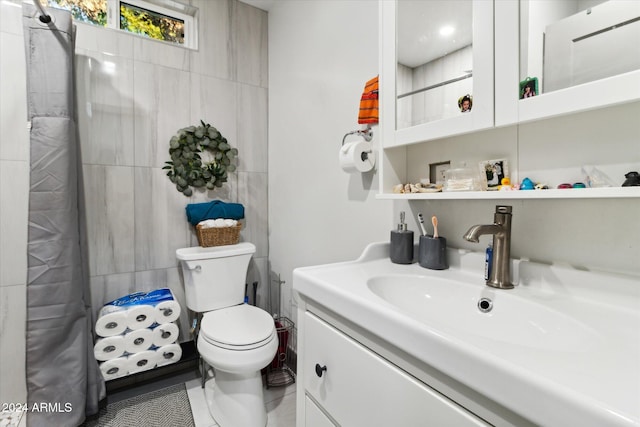 bathroom featuring tile patterned flooring, vanity, a shower with shower curtain, and toilet