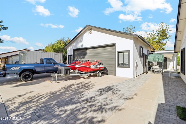 view of side of home featuring a garage and an outdoor structure