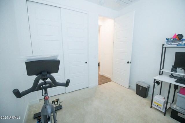 workout room featuring carpet floors and baseboards