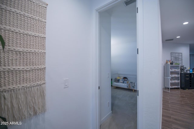 hall with recessed lighting and wood finished floors