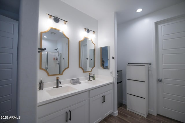 full bathroom featuring wood tiled floors, double vanity, recessed lighting, and a shower