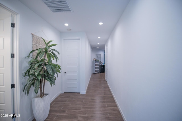 corridor with recessed lighting, baseboards, and dark wood-style flooring