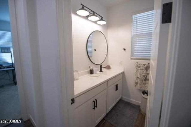 bathroom with vanity and baseboards