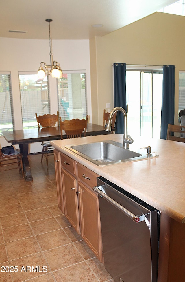 kitchen with brown cabinets, decorative light fixtures, light countertops, a sink, and dishwasher