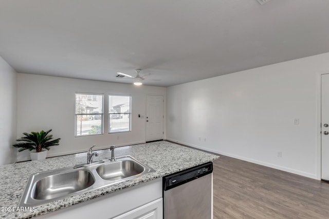 kitchen with light stone counters, sink, dishwasher, hardwood / wood-style floors, and white cabinetry