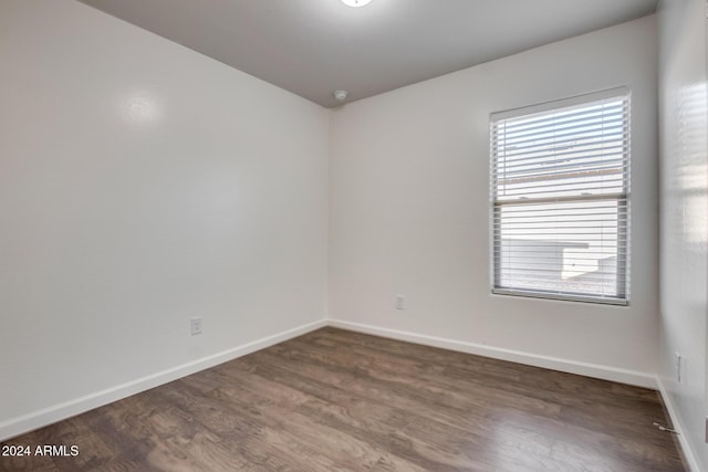 spare room with dark hardwood / wood-style flooring