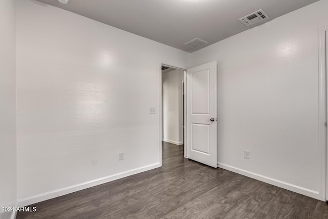 unfurnished bedroom featuring dark hardwood / wood-style flooring