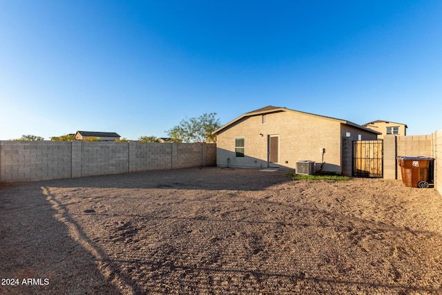 rear view of property featuring central AC