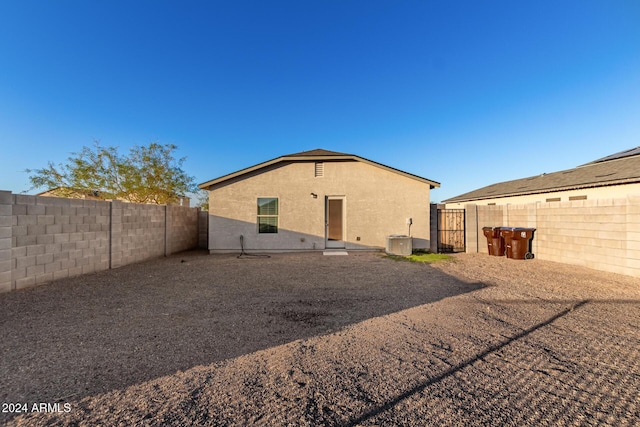 back of property featuring central AC