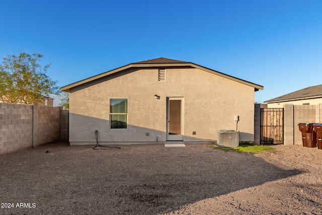 rear view of property featuring cooling unit