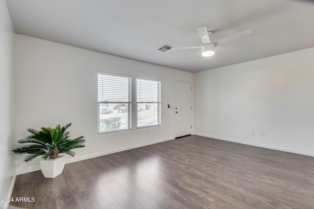 spare room featuring dark hardwood / wood-style floors and ceiling fan