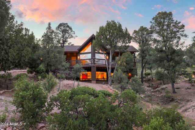 rear view of property featuring a deck